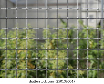 wire mesh from a rabbit aviary. The mesh protects animals from people and birds of prey, highlighting the mesh structure.