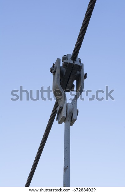 Wire rope, with\
custom made attachments used in the construction of a swing bridge.\
Incorporating a wire rope clamp, housed in monkey plates which\
connect to an eye bolt.