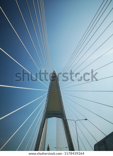 The wire rope fastened the bridge\
over the river to the beautiful backdrop of the\
sky.