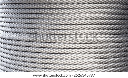 Wire rope sling background. Reel of silver steel sling on roll coil