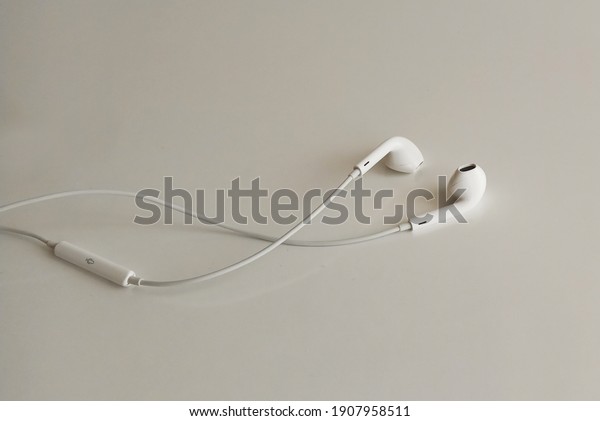 Wired headphone isolated on white background.\
Close up mobil phone\
headphones.