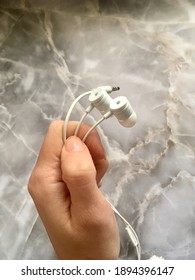 Wired Headphones In Hand.  Mobile Photo