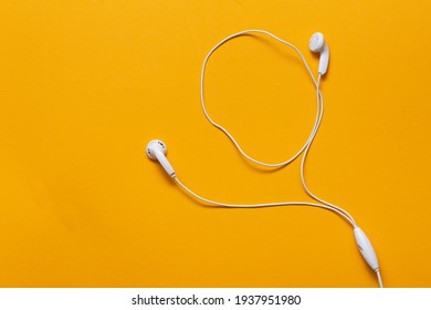 Wired Headphones On Yellow Background