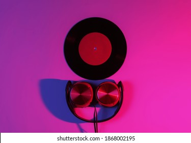 Wired Headphones And Vinyl Record With Neon Blue-red Gradient Light. Retro Wave, 80s Pop Culture. Top View