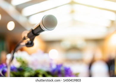 Wired microphone set up on the front of conference room close up with blurred background.  Wired microphone close up with copy space background.