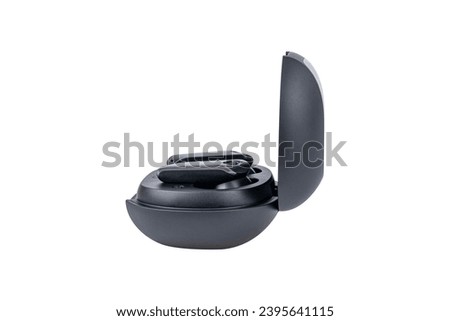 Wireless black bluetooth earphones with contactless charging isolated on white background.