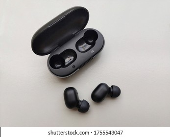 Wireless bluetooth earbuds or earphone with case isolated on white background