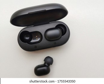 Wireless Bluetooth Earphone On A White Background. Closeup Isolated
