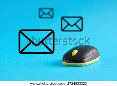 Wireless computer mouse with email icons hovering over it, representing sending and receiving messages
