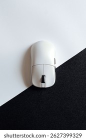 Wireless computer mouse on black and white background, top view for promotional branding.
