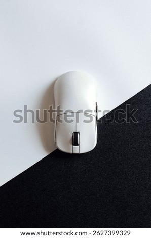 Wireless computer mouse on black and white background, top view for promotional branding.