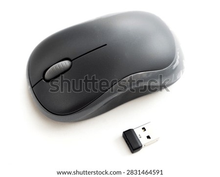 A wireless computer mouse and USB receiver on a white background