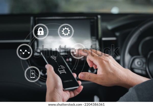 Wireless connection technology in the smart
car and virtual screens concept, Man use the smartphone  online to
a car ,Connecting to the car system and safety technology,car
inside background