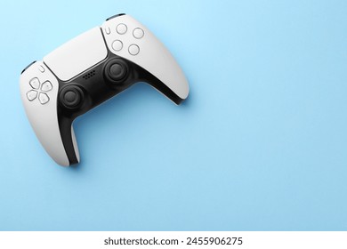 Wireless game controller on light blue background, top view. Space for text - Powered by Shutterstock