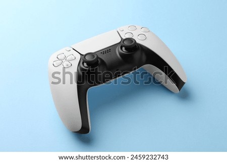 Wireless game controller on light blue background
