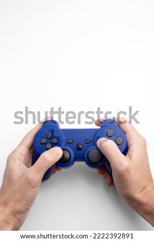 a wireless gamepad in hand