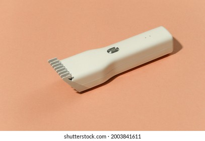 Wireless hair clipper on bright orange background. - Powered by Shutterstock