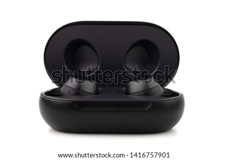 Wireless headphones on a white background. Headset close up in the charging case close-up.