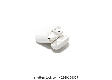 Wireless headphones, with rechargeable case. Isolated on white background. Concept of the latest in electronics.