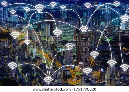 Wireless Internet. Lines go from one WiFi icon to another. WiFi icons over residential buildings. Night megalopolis. Concept - WiFi transmitters are installed on roofs. Public Internet Access Network