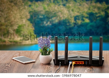 Wireless internet router with connected cables, The backside of fiber optic internet, and network cables connected to a router. Internet security and hi-speed concept. Selective focus.Close-up