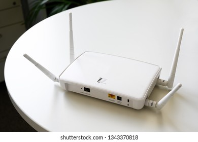 Wireless Internet Router With Connection For Ethernet And Console On A White Table In The Office, Copy Space, Selected Focus, Narrow Depth Of Field