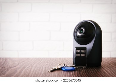 Wireless IP webcam with a motion detection and keys for home access. Safety and house control