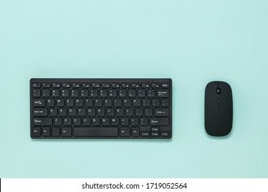 Wireless keyboard and mouse on a light blue background. 