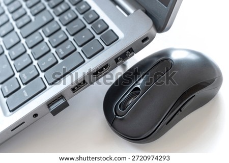 Wireless mouse and USB receiver plugged into laptop