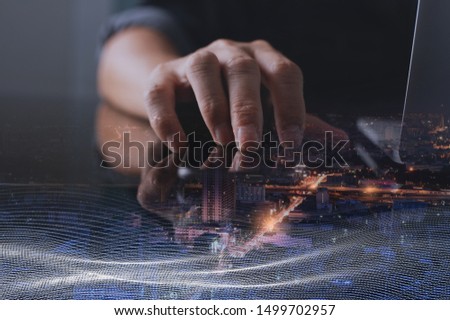 Wireless network communication, digital technology development, smart city concept. Double exposure, business man using smart phone, digital tablet, laptop computer, smart city with network connection