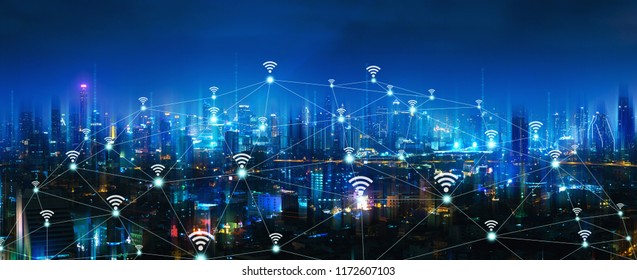 Wireless network and Connection technology concept with Bangkok city background at night in Thailand, panorama view