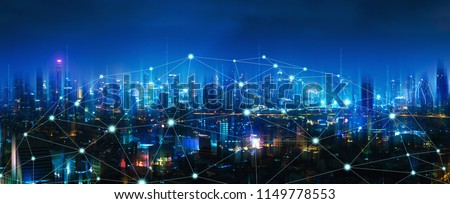 Wireless network and Connection technology concept with Bangkok city background at night in Thailand, panorama view