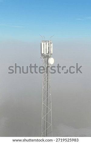 Wireless network tower standing in misty winter scenery