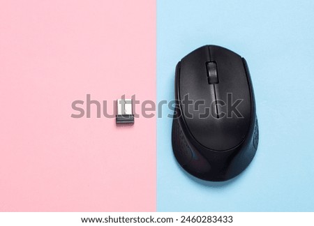 Wireless PC mouse with USB flash drive on pink blue background