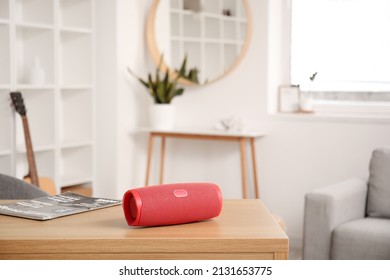 Wireless portable speaker on wooden table in light room - Shutterstock ID 2131653775