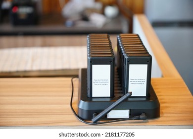 Wireless Queue Calling On Wooden Table At Coffee Shop.