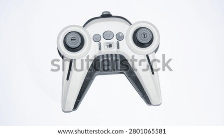 Wireless remote controller isolated on a green background. Modern electronic device featuring dual joysticks, suitable for drone operation, gaming technology, smart control, and innovation concepts.