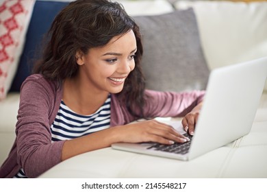 Its A Wireless And Worry Free Weekend. Shot Of A Young Woman Using Her Laptop While Sitting On The Floor.