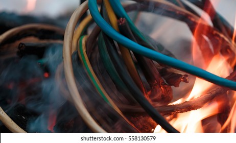 wires on fire. Firing winding insulation of electrical wiring in the fire in the winter woods
