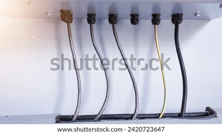 Wiring power input output with cable glands protection on the electric  panel control. Cable connection from control panel to tray cabinet cable lines.