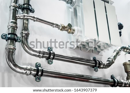 wiring of radiator pipes in the room on the wall. Example of pipe wiring