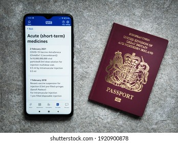 Wirral, UK - Feb 20 2020: The UK's NHS Smartphone App Shows Evidence Of An Oxford AstraZeneca COVID Vaccination Given Given On 2nd February 2021. A UK Passport Appears On The Right.