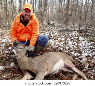 Wisconsin Deer Hunter With A Spike Buck In The Woods