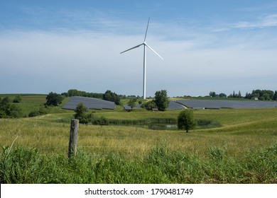 WISCONSIN, UNITED STATES - Jul 07, 2020: Wind Turbine And Solar Panels For Sustainable Energy On A Farm