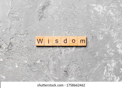 wisdom word written on wood block. wisdom text on table, concept.