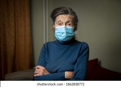 Wise look of old woman with medical mask on face encourages you to keep your distance and use protective equipment, health safety during an covid 19. Portrait of senior looking at camera, elderly care