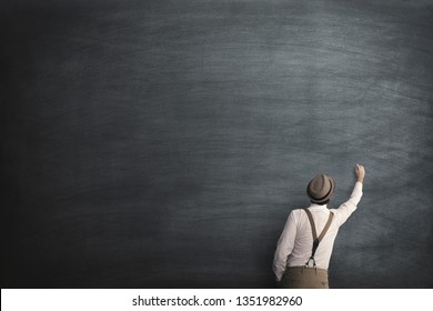 wise man start writing on a empty blackboard - Powered by Shutterstock