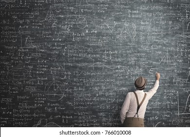 wise man writing mathematical problem solution - Shutterstock ID 766010008