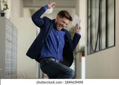 Wish Come True. Euphoric Happy Male Executive Employee Manager Worker Jumping Dancing At Office Hallway Screaming In Delight Getting Career Salary Growth, Finding Hard Solution, Receiving Job Of Dream