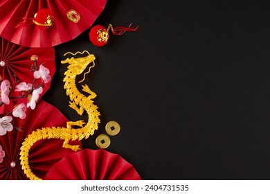 Wishing a joyful Chinese New Year 2024. Top view photo of gold dragon, paper fans, lucky coins, decorative elements, sakura on black background with advert space